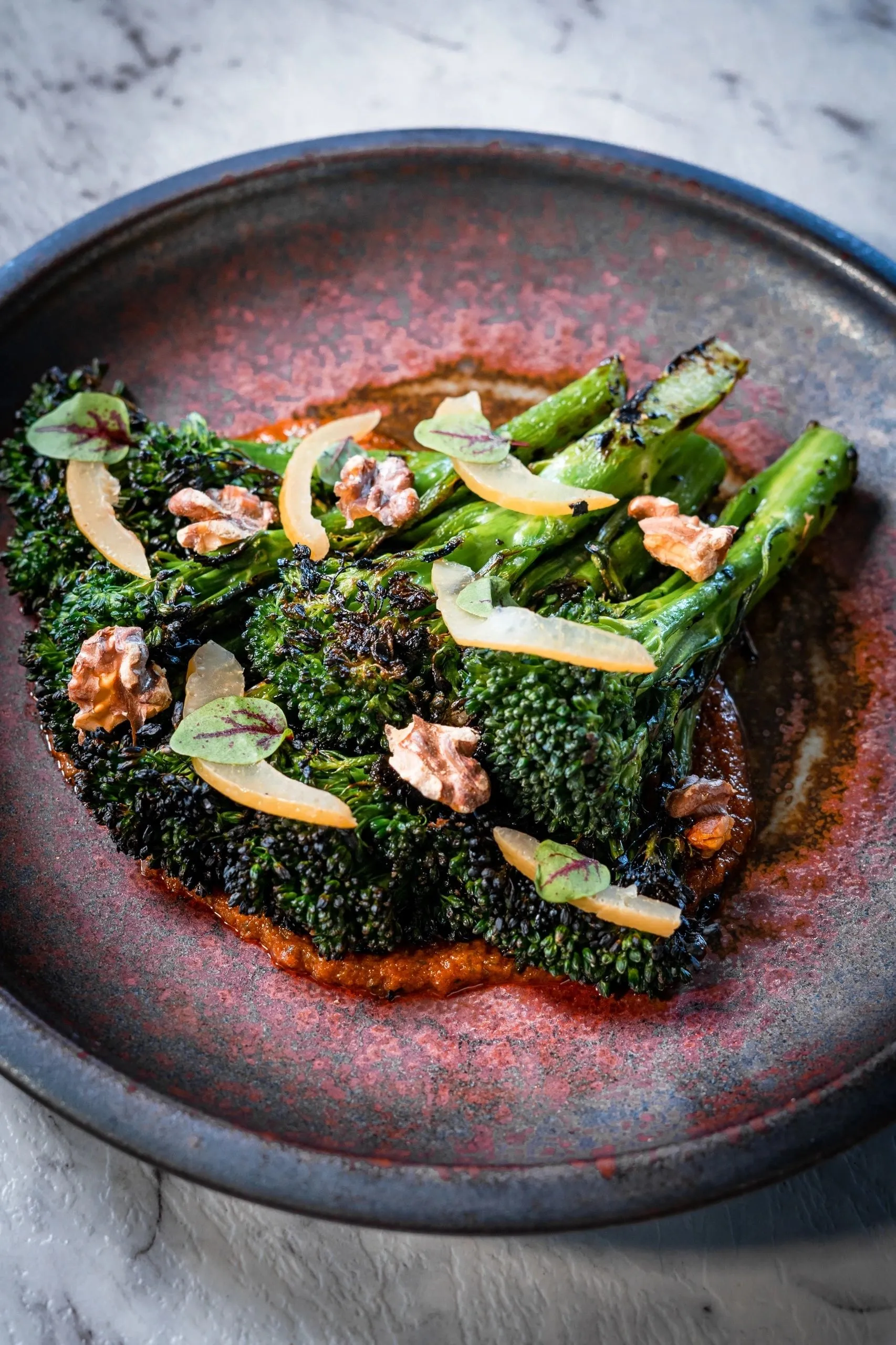Charred broccolini on romesco with walnuts and preserved lemon