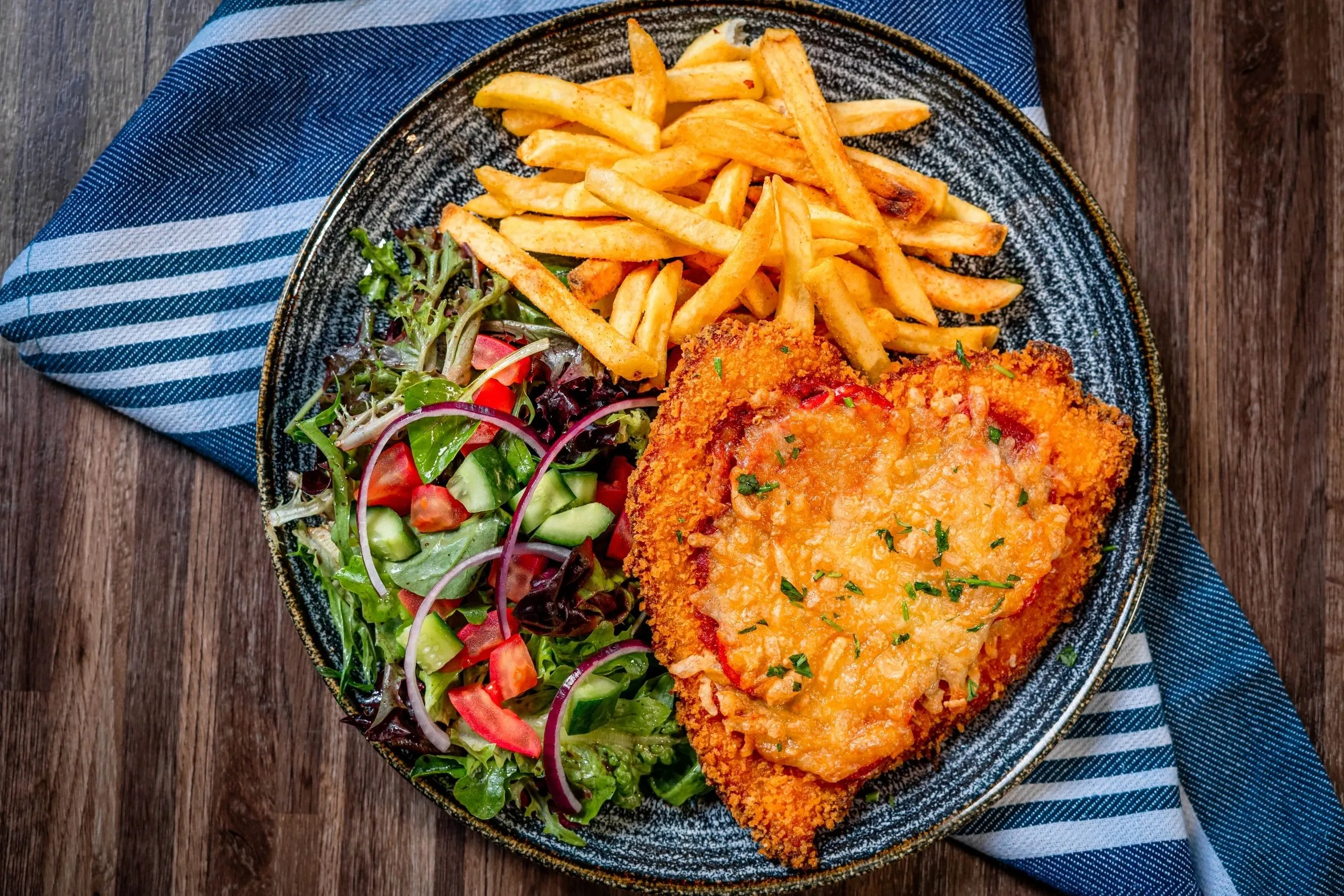 Chicken parmigiana with chips and garden salad