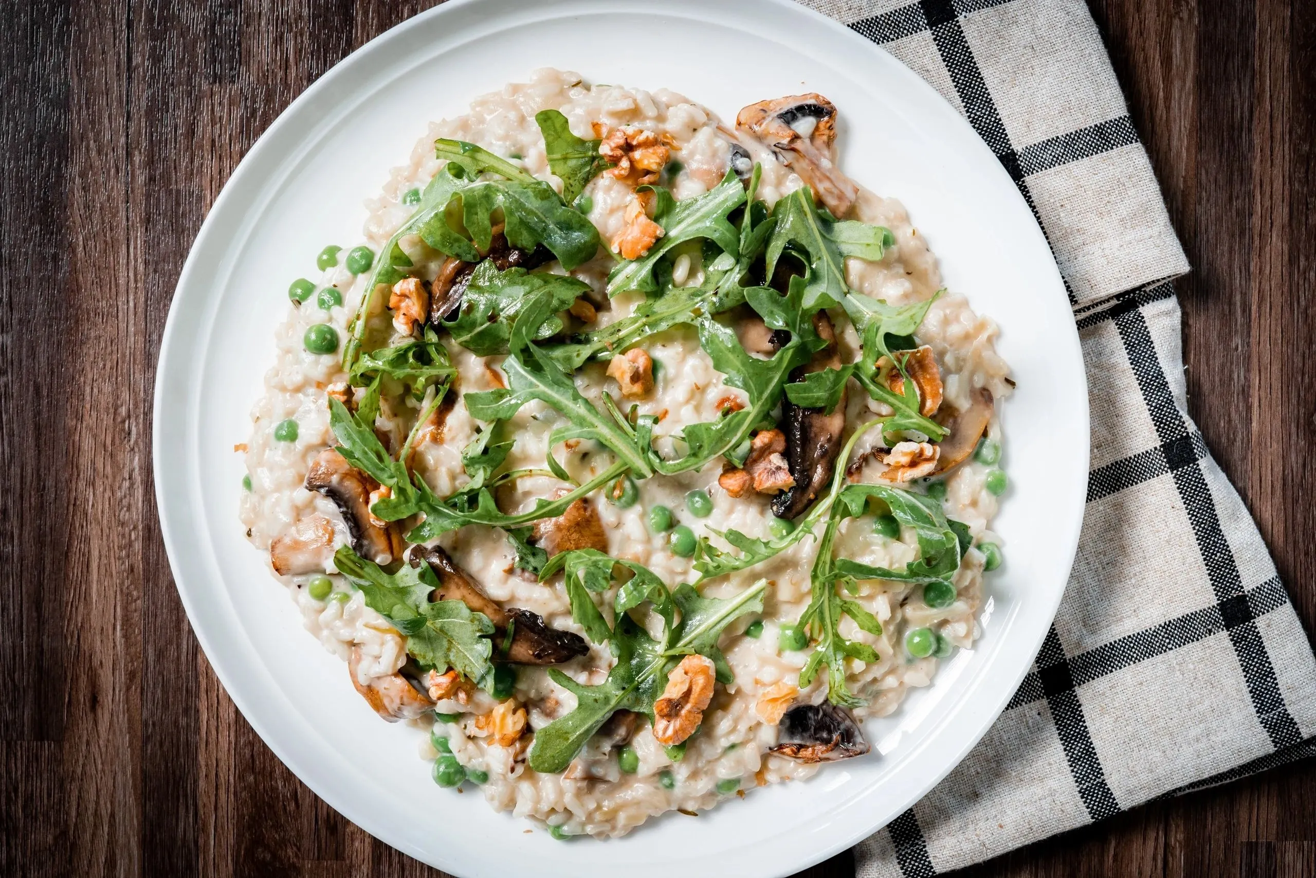 Mushroom and pea risotto with rocket and walnuts