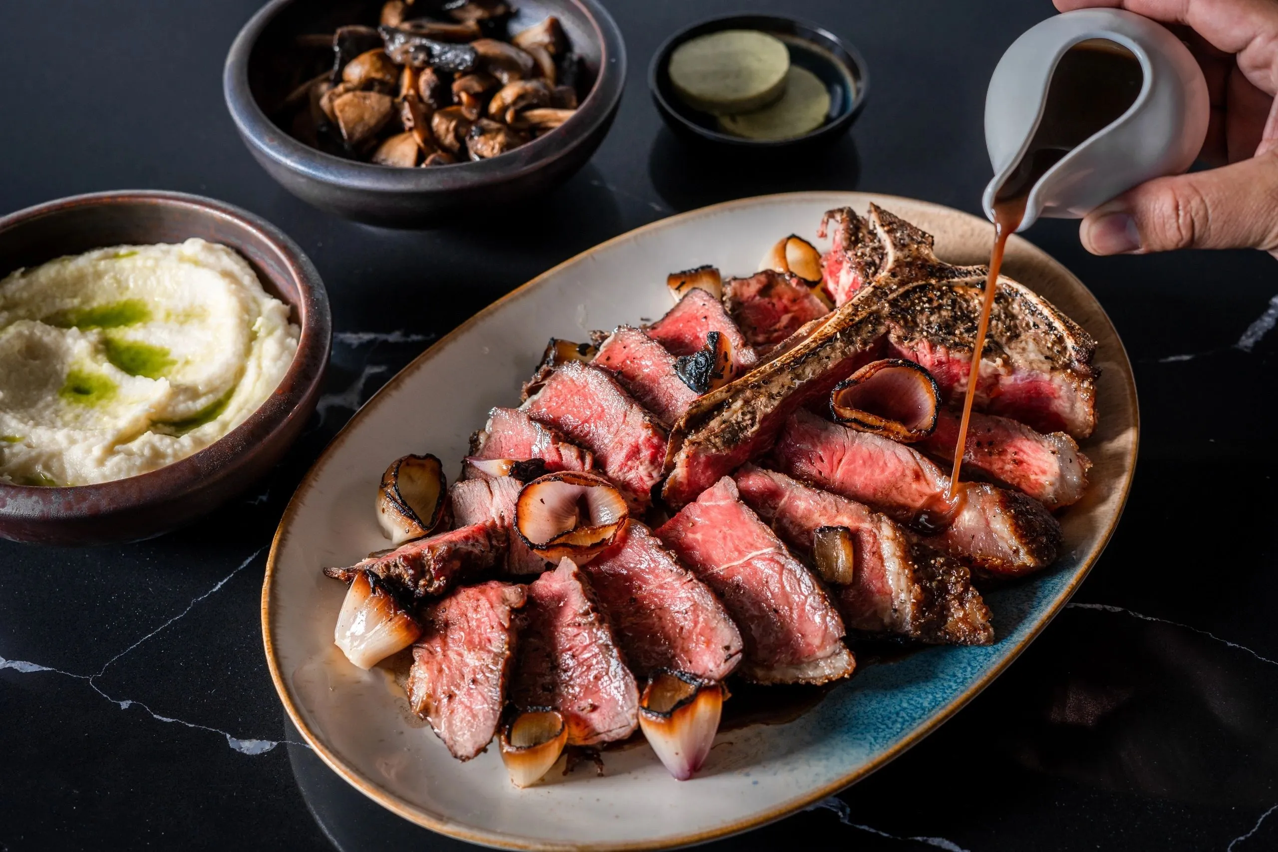 The signature T-bone, carved and fanned on a platter as brandy jus is poured