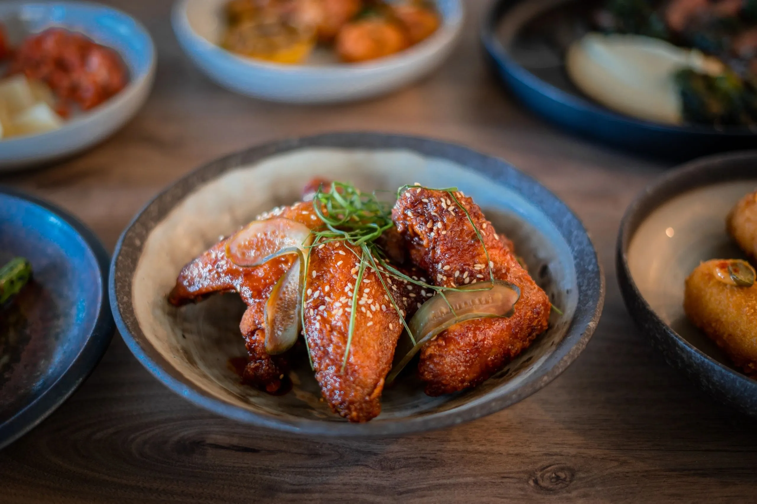 Sticky glazed chicken wings with sesame, spring onion and pickles